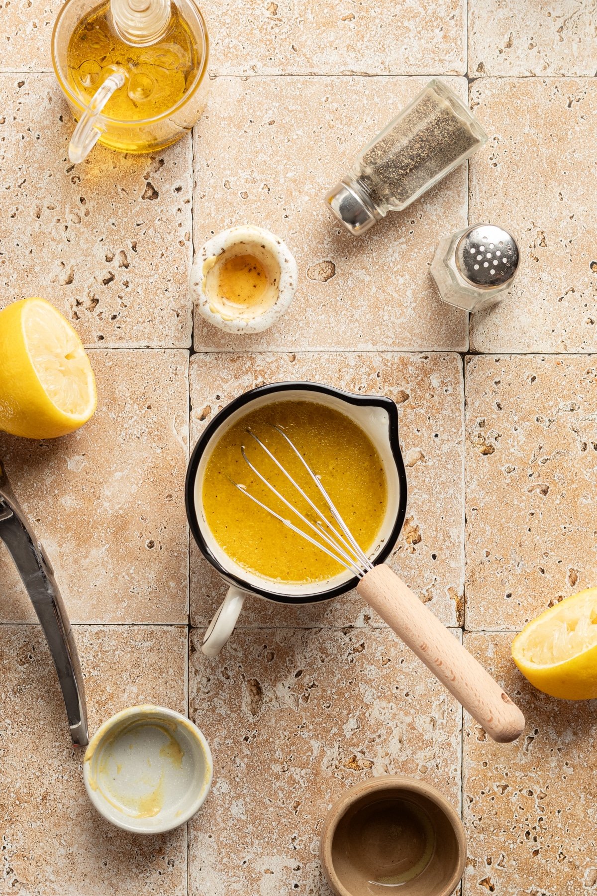 White balsamic dressing mixed in a small bowl with a whisk.