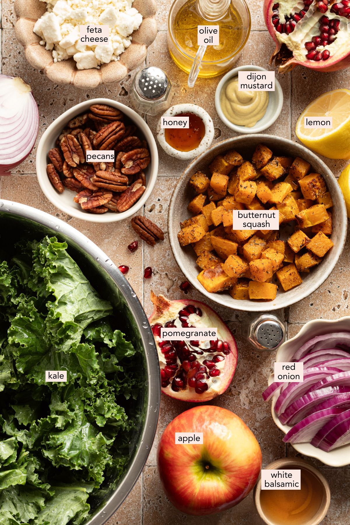 Ingredients for kale butternut squash salad on a countertop with labels.