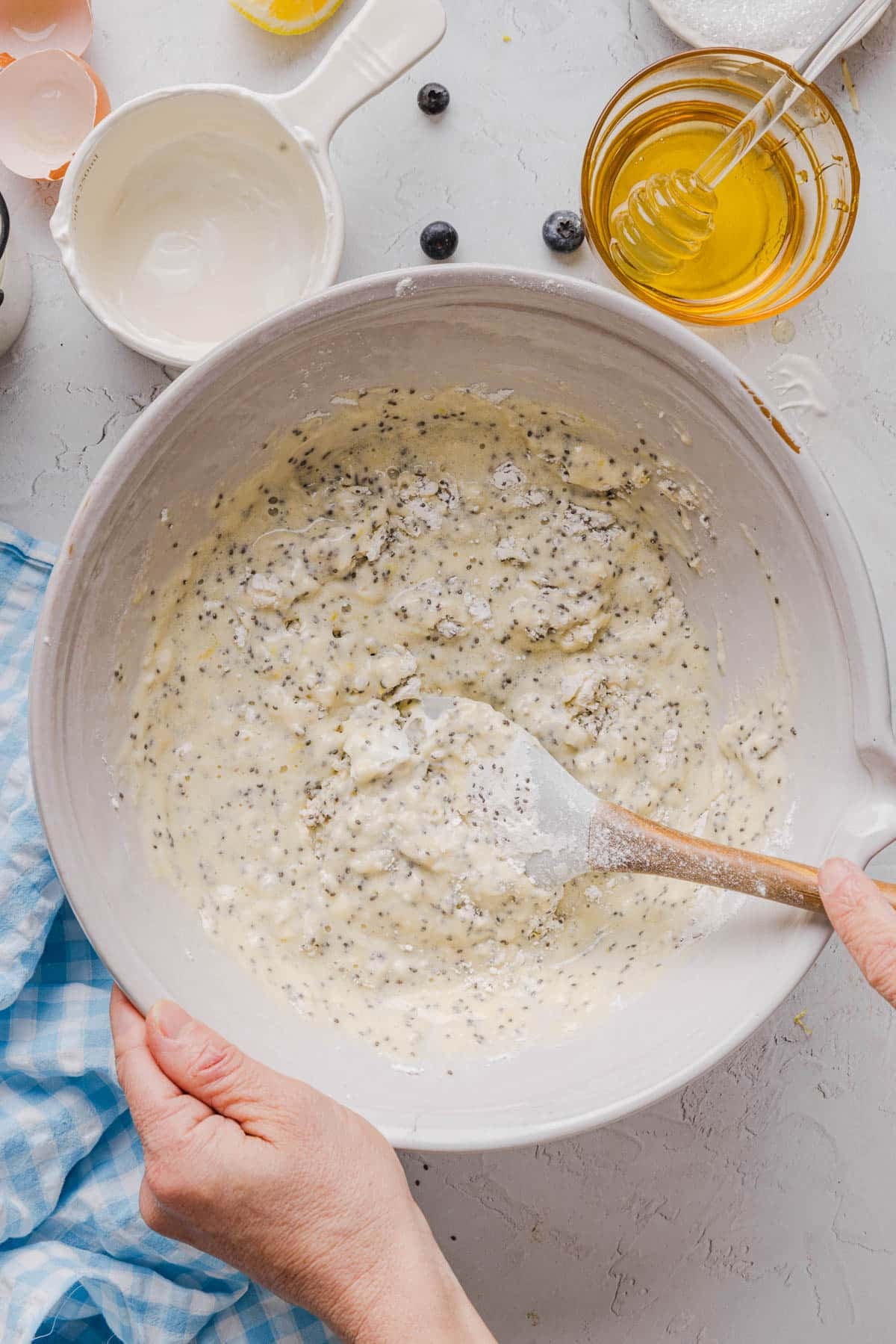 The wet ingredients mixed into the fry ingredients in a white bowl on a countertop.