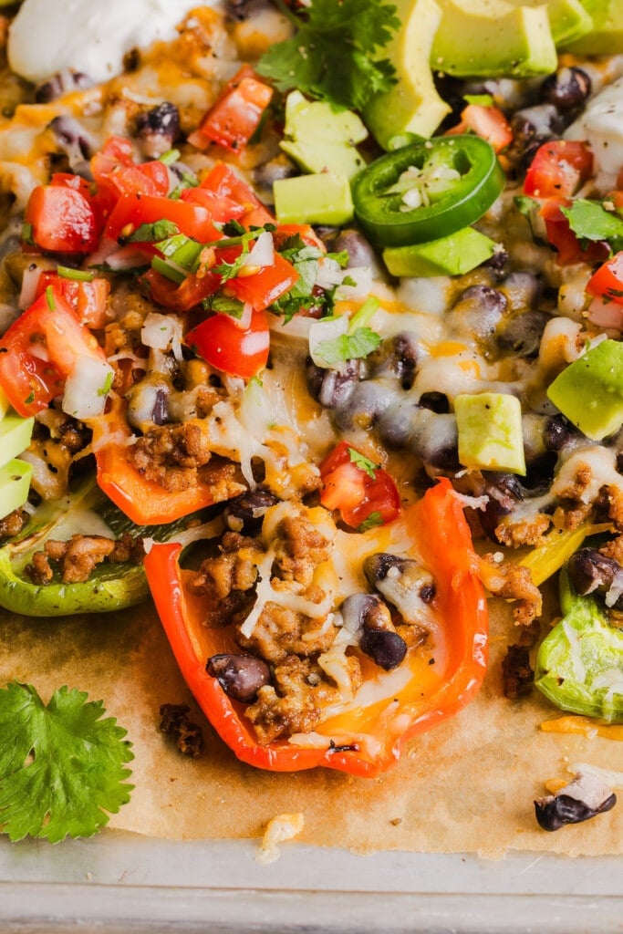 Bell pepper nachos with ground taco meat and toppings.