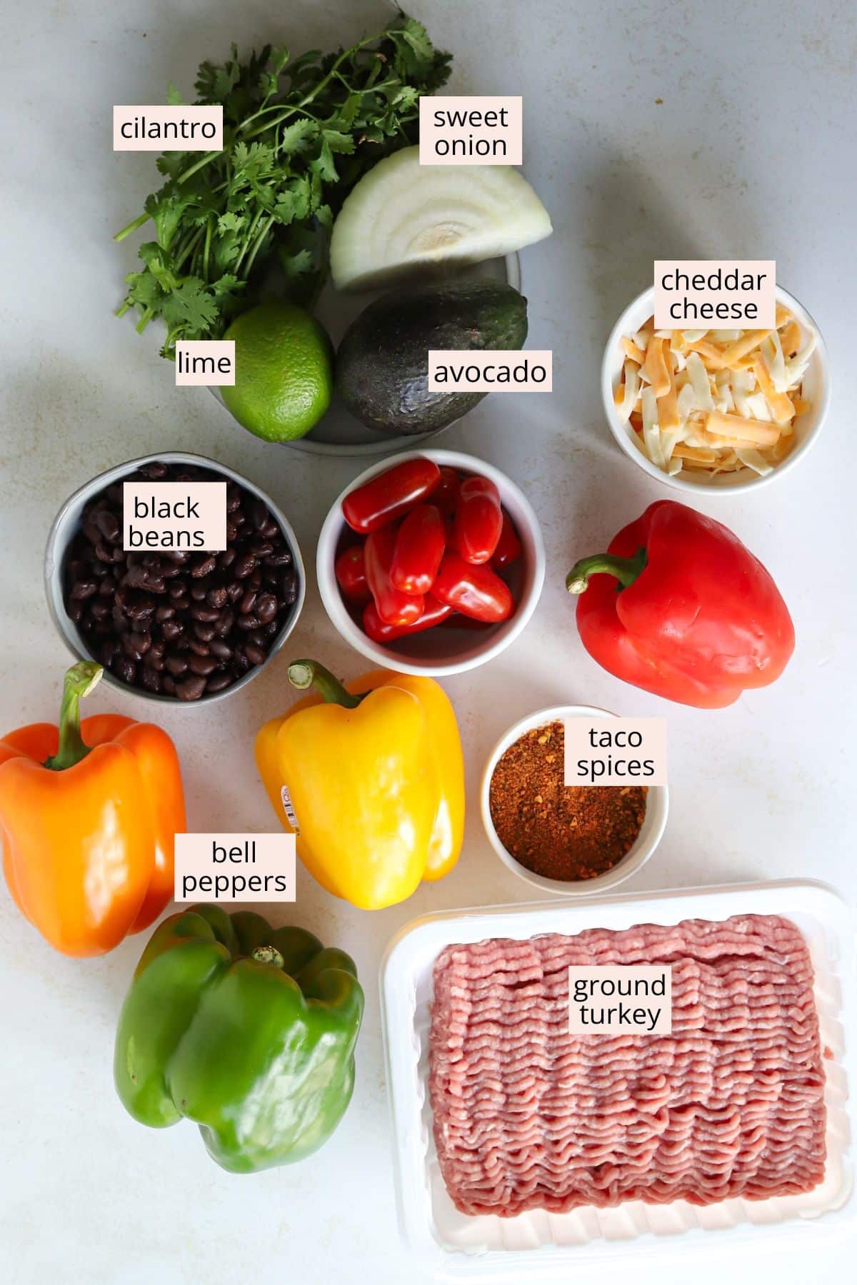 Bell peppers and other ingredients for bell pepper nachos arranged on a countertop with labels.