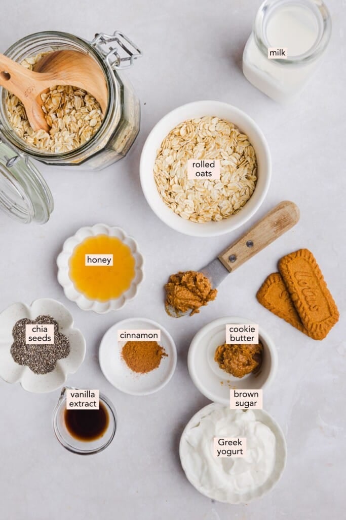 Ingredients for biscoff overnight oats on a countertop with labels.