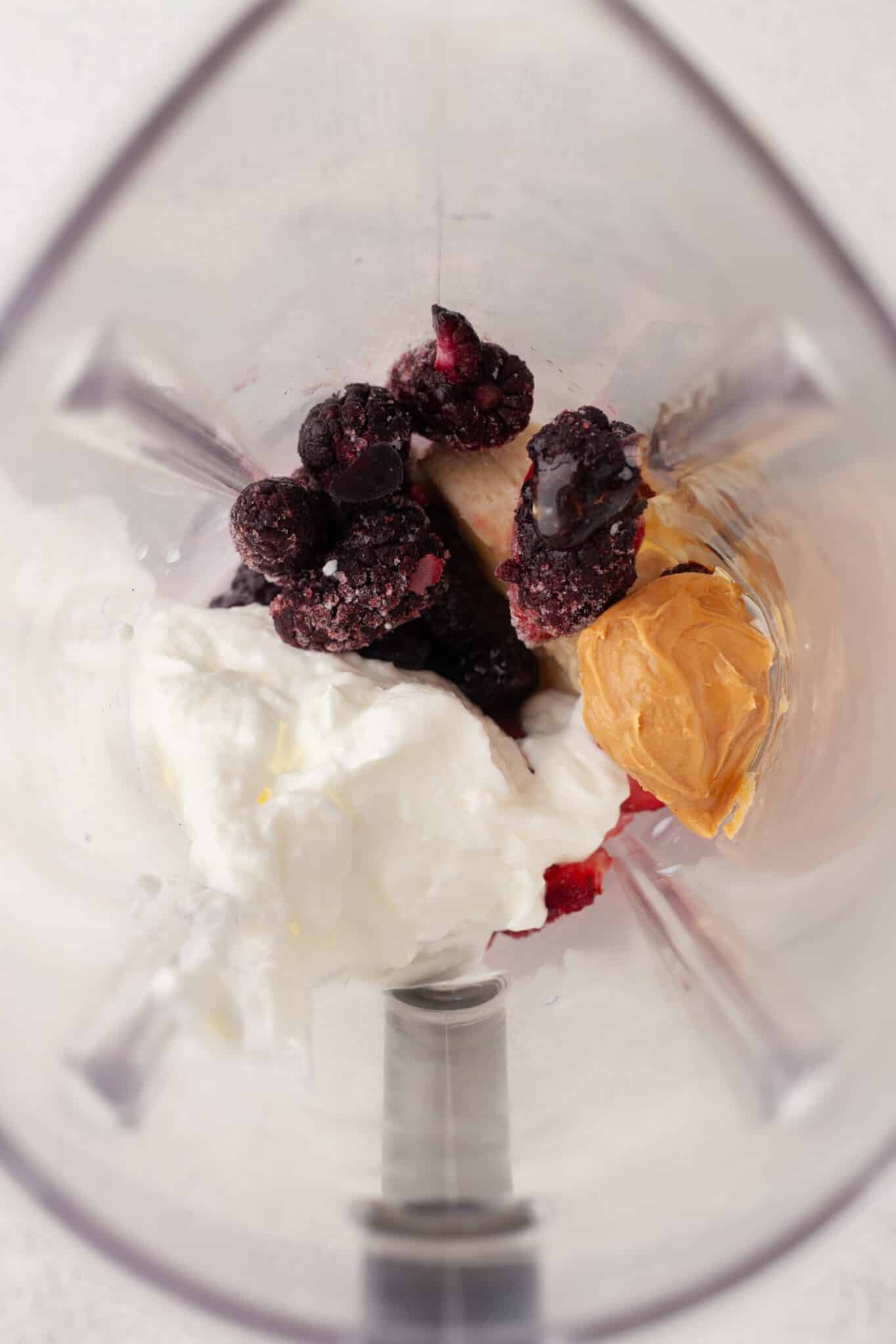 Blackberry smoothie ingredients in a blender.