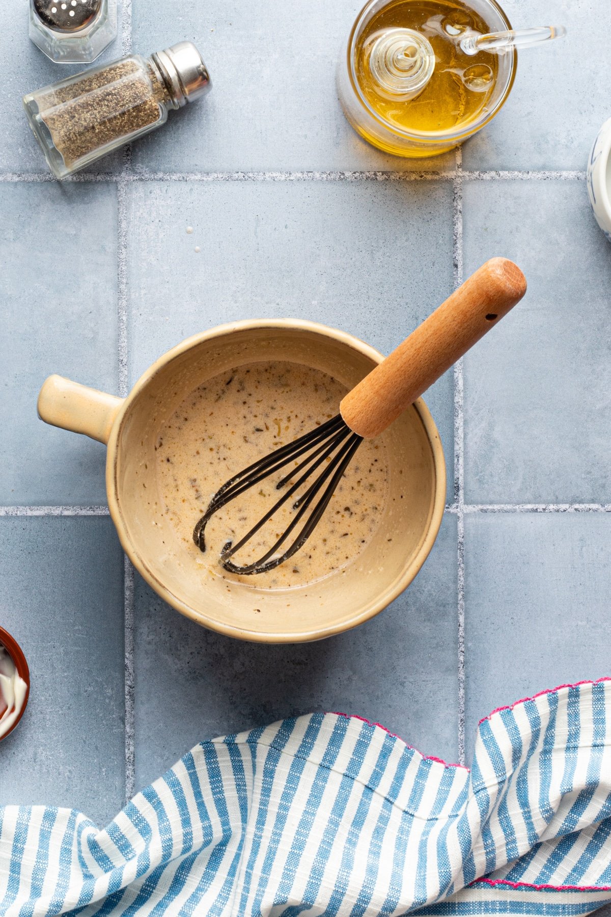 Creamy Italian dressing in a bowl with a whisk.