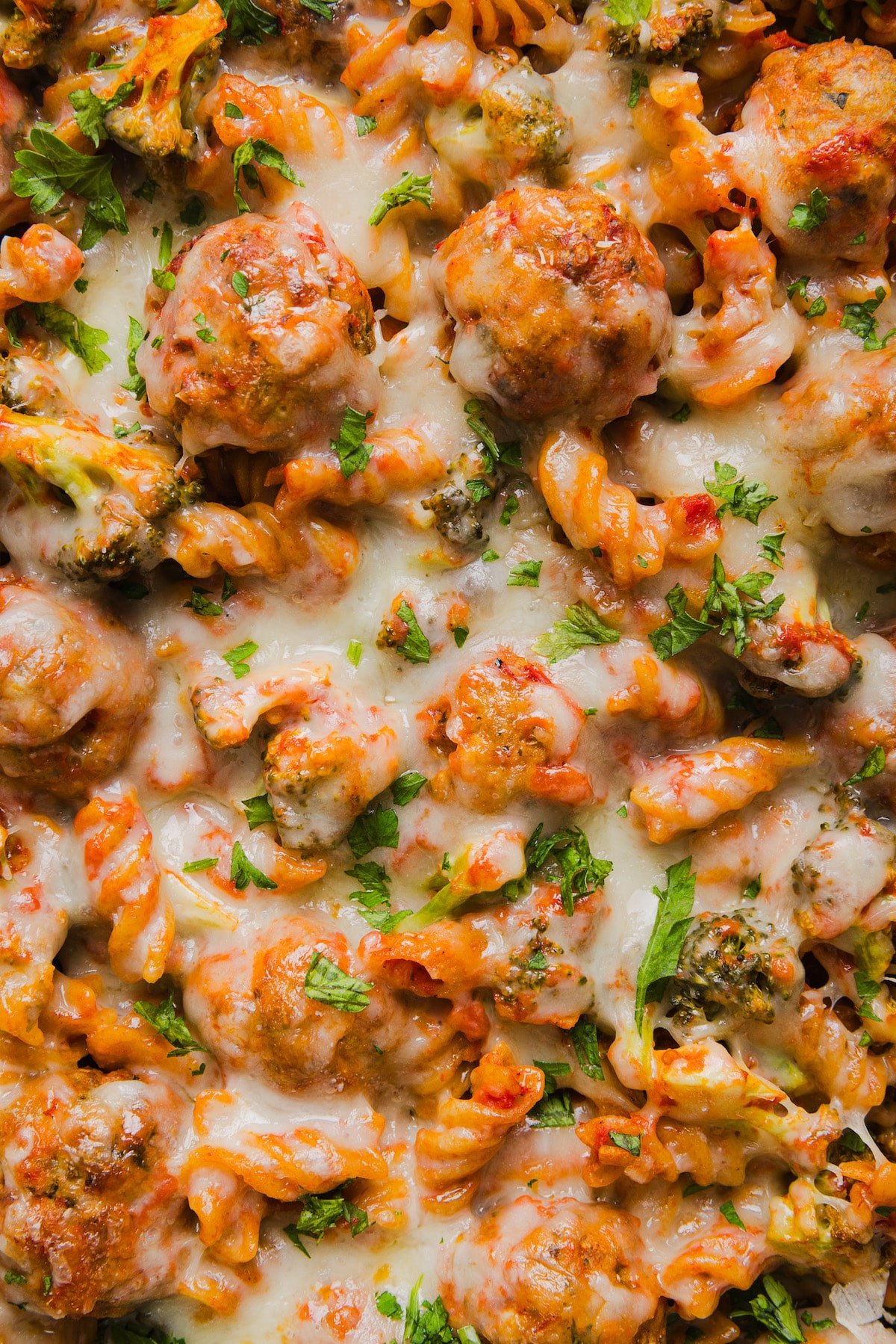 This dump and bake meatball casserole is easy, family-friendly and super simple. Throw your ingredients in a dish, and bake! A close up shot of dump and bake meatball casserole.