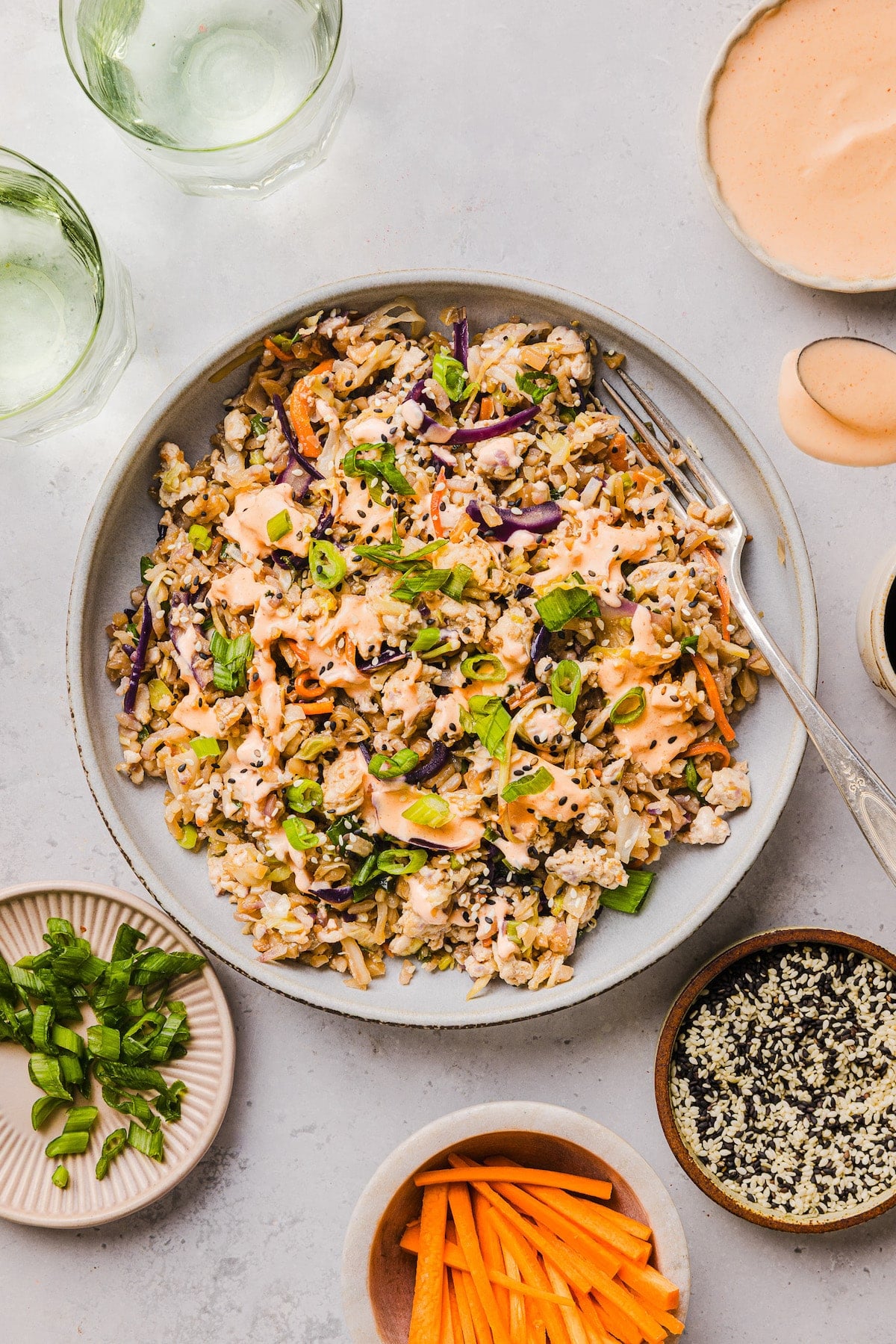This is the BEST egg roll in a bowl recipe! It takes less than 20 min and uses one pan. An easy, satisfying dinner idea everyone loves. Inside out egg roll bowl in a plate with a fork.