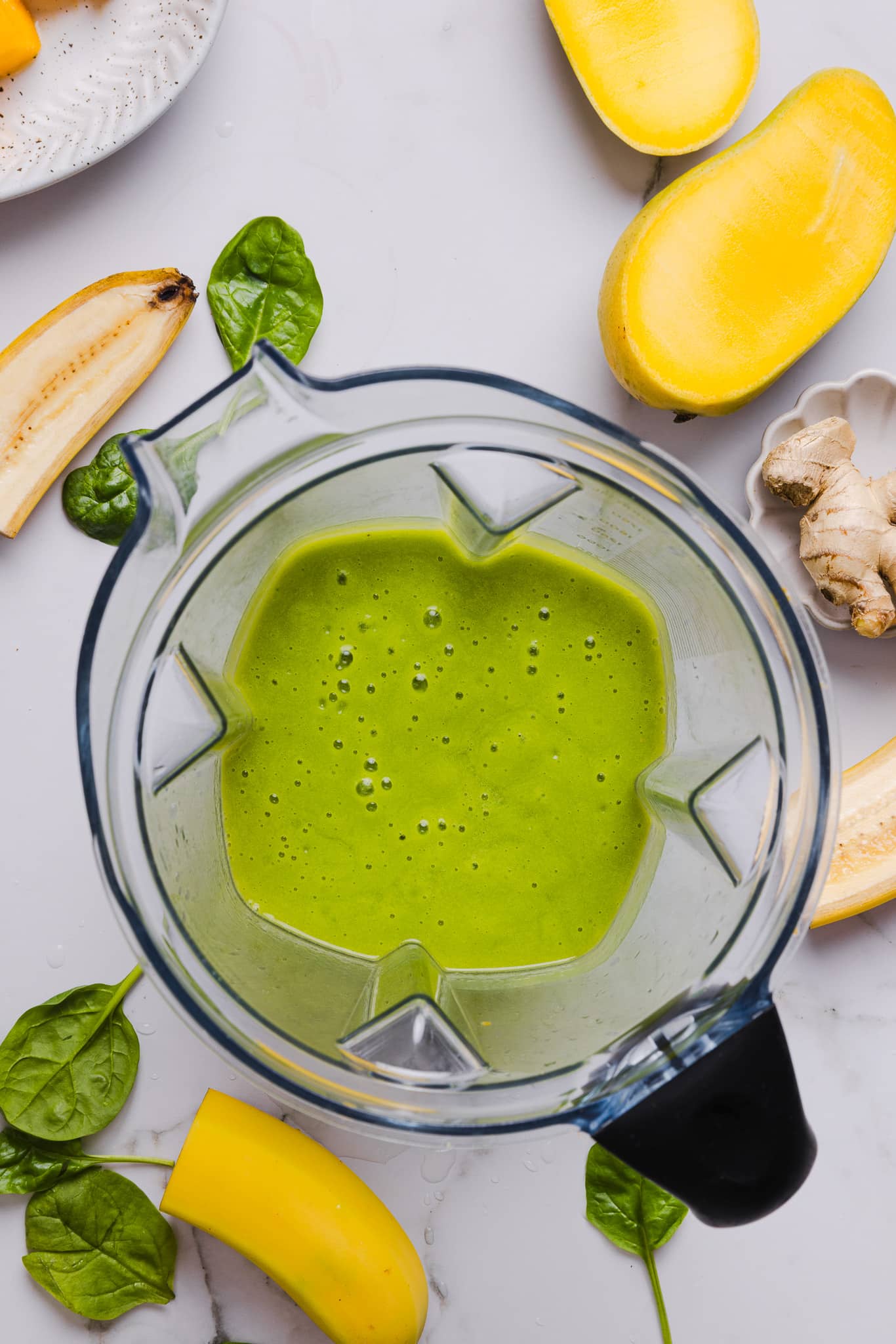 A green smoothie blended in a blender.