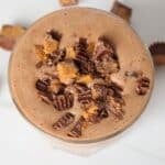 An overhead shot of the Tropical Smoothie Peanut Butter Cup smoothie, topped with chopped peanut butter cups.
