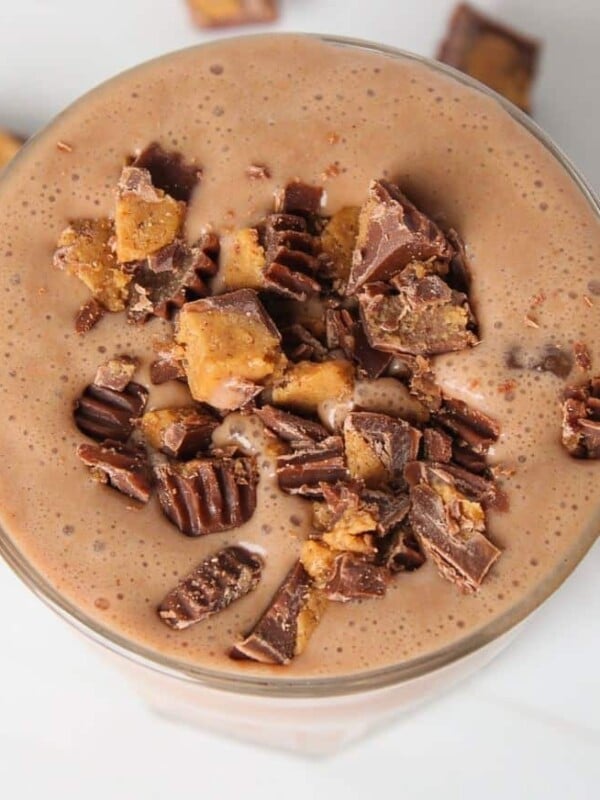 An overhead shot of the Tropical Smoothie Peanut Butter Cup smoothie, topped with chopped peanut butter cups.