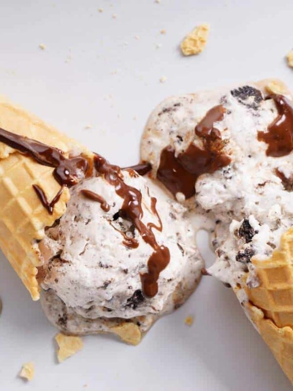 Two chocolate cones drizzled with chocolate sauce