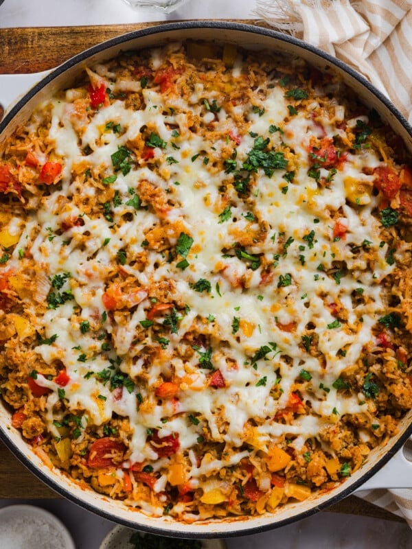 Deconstructed stuffed peppers in a skillet with melted cheese on top.