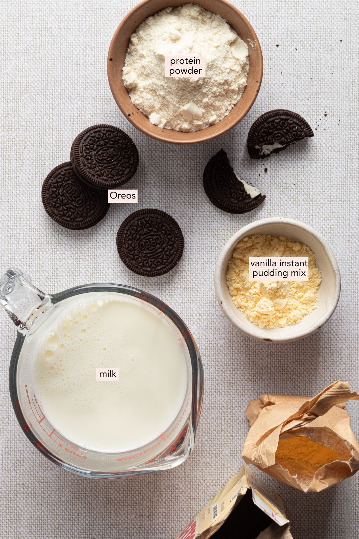 Ingredients for Ninja Creami cookies and cream ice cream on a countertop with labels.