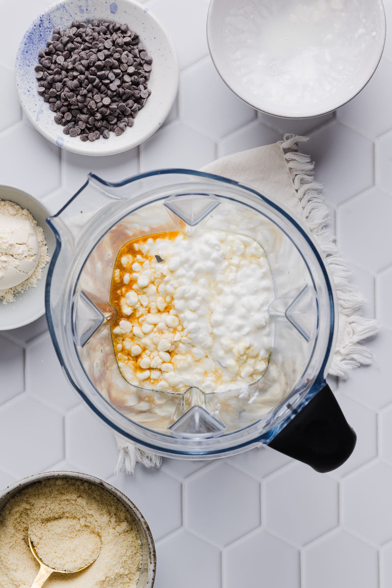 Cottage cheese, maple syrup, and vanilla extract in a blender.