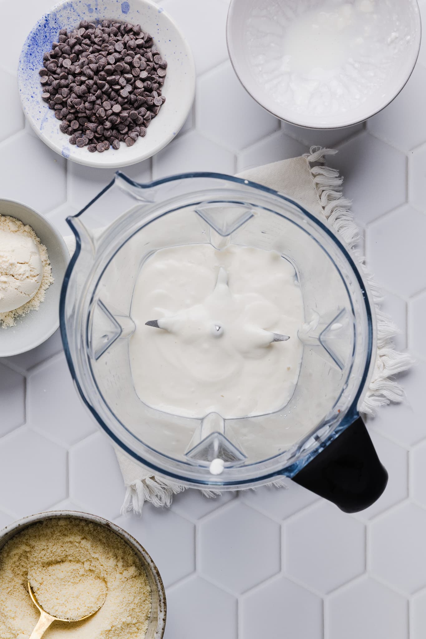 Cottage cheese, maple syrup, and vanilla extract blended in a blender.