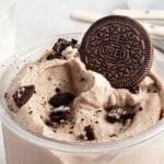 Ninja creami cookies and creami ice cream in a pint container topped with Oreos.