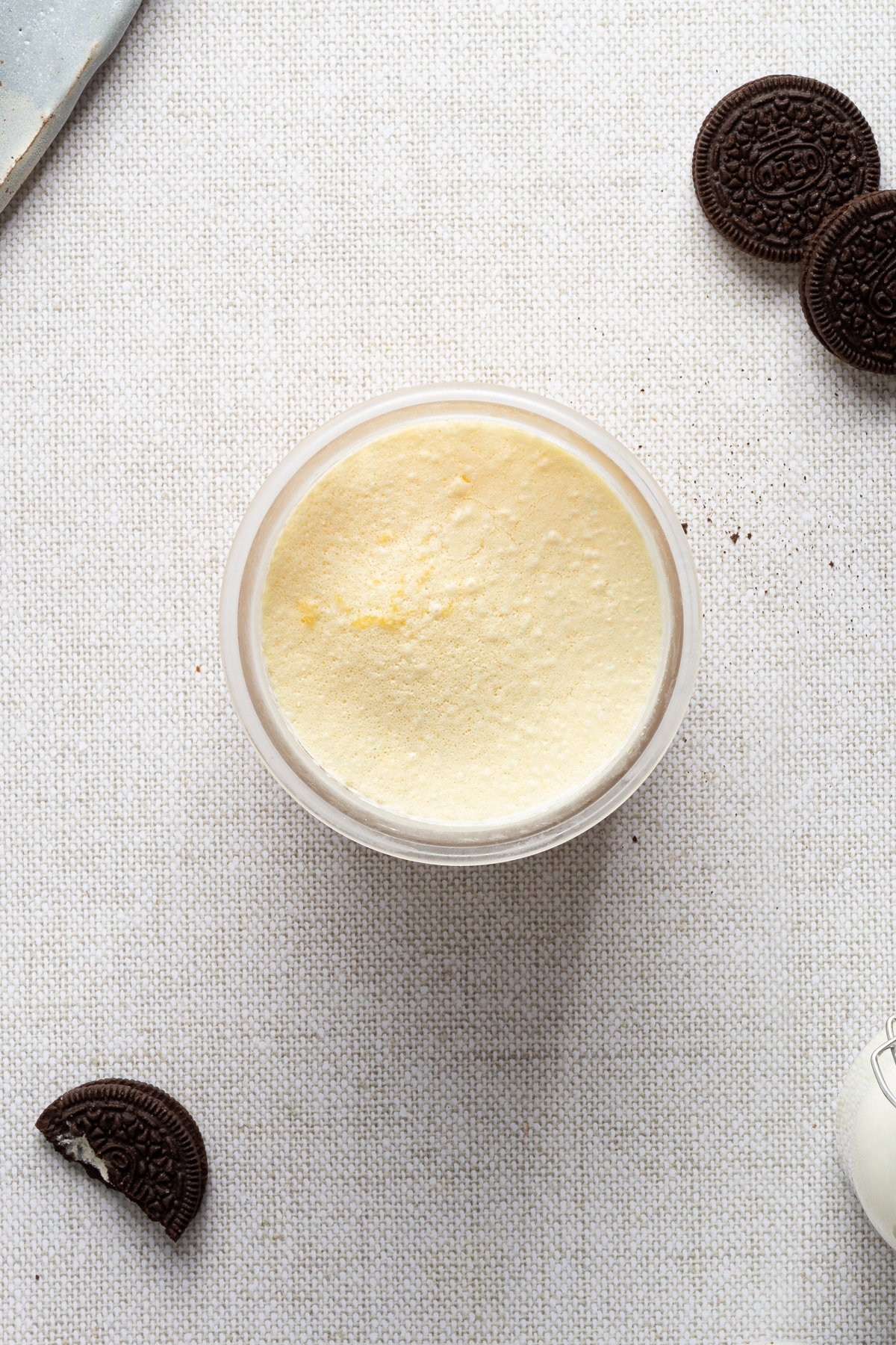 Frozen vanilla ninja creami ice cream in a pint container.