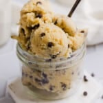 Cottage cheese cookie dough scooped into a mason jar with a spoon.