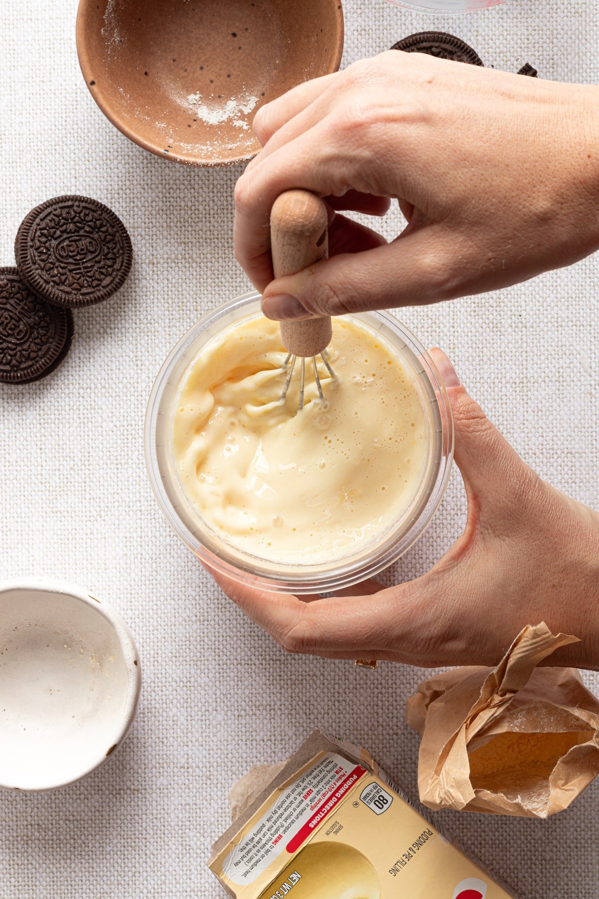Vanilla base for ninja cream cookies and cream being mixed up in a pint container.