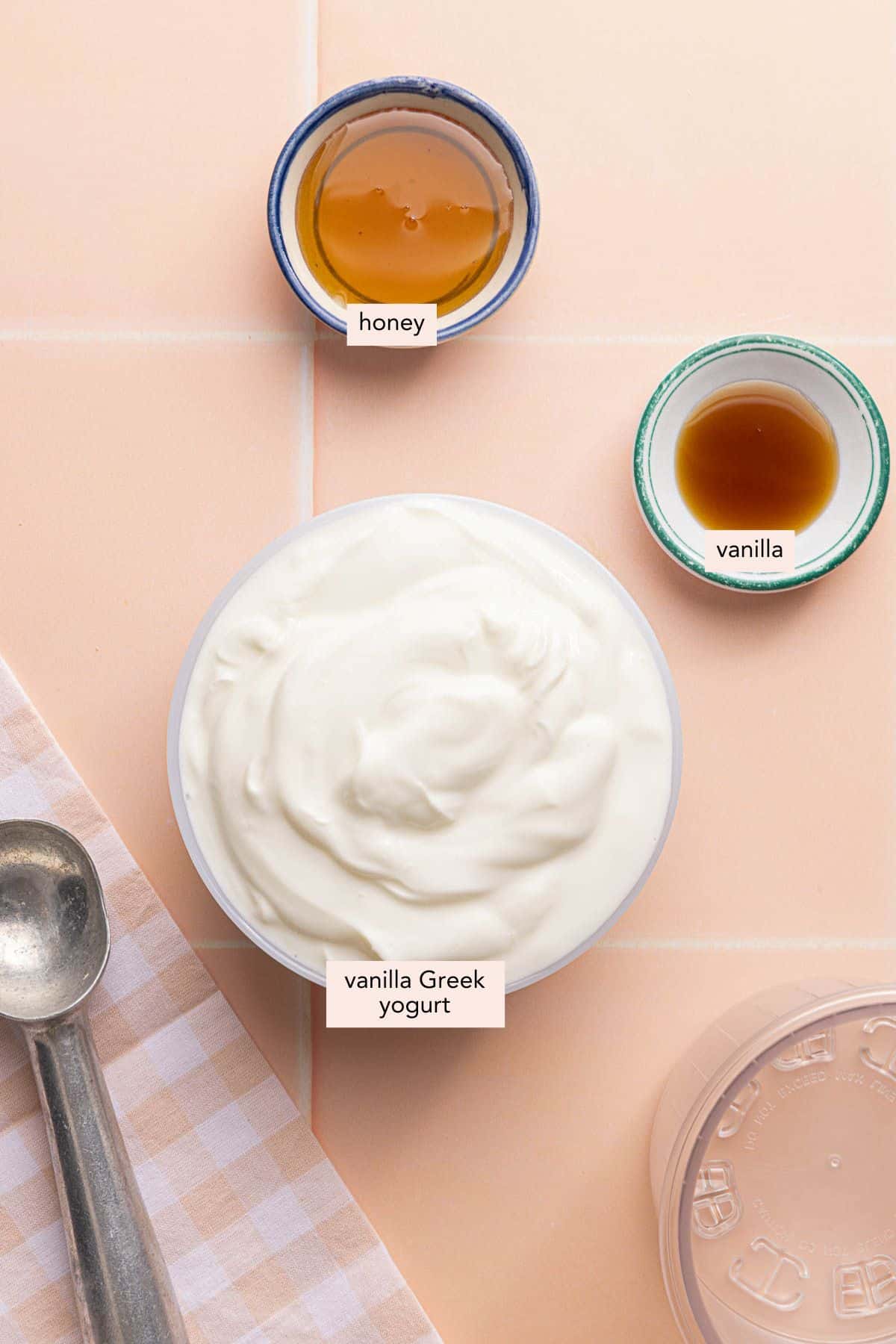 All of the ingredients for Ninja Creami Frozen Yogurt in bowls on a countertop.