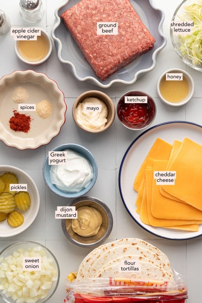 Ingredients for big mac smash burger tacos on a countertop with labels.