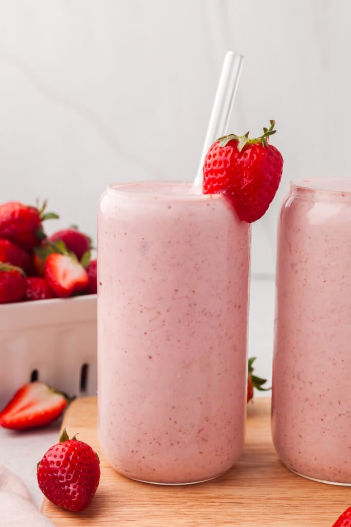 Two cottage cheese smoothies garnished with strawberry.