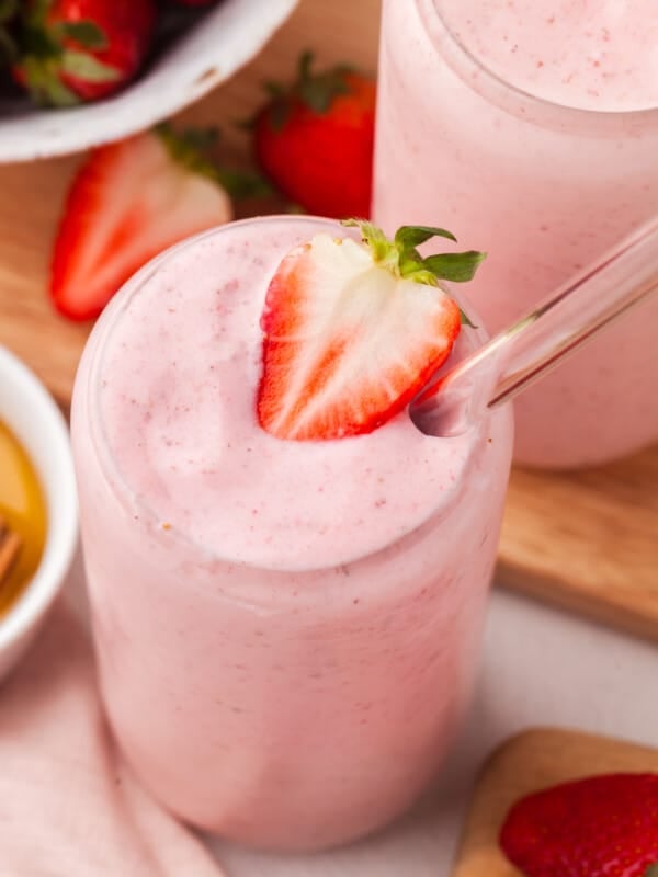A close up shot of cottage cheese smoothie garnished with a slice of strawberry.