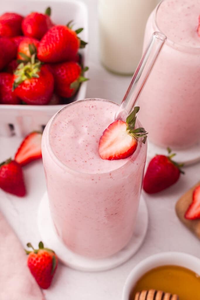 A cottage cheese smoothie garnished with a slice of strawberry.