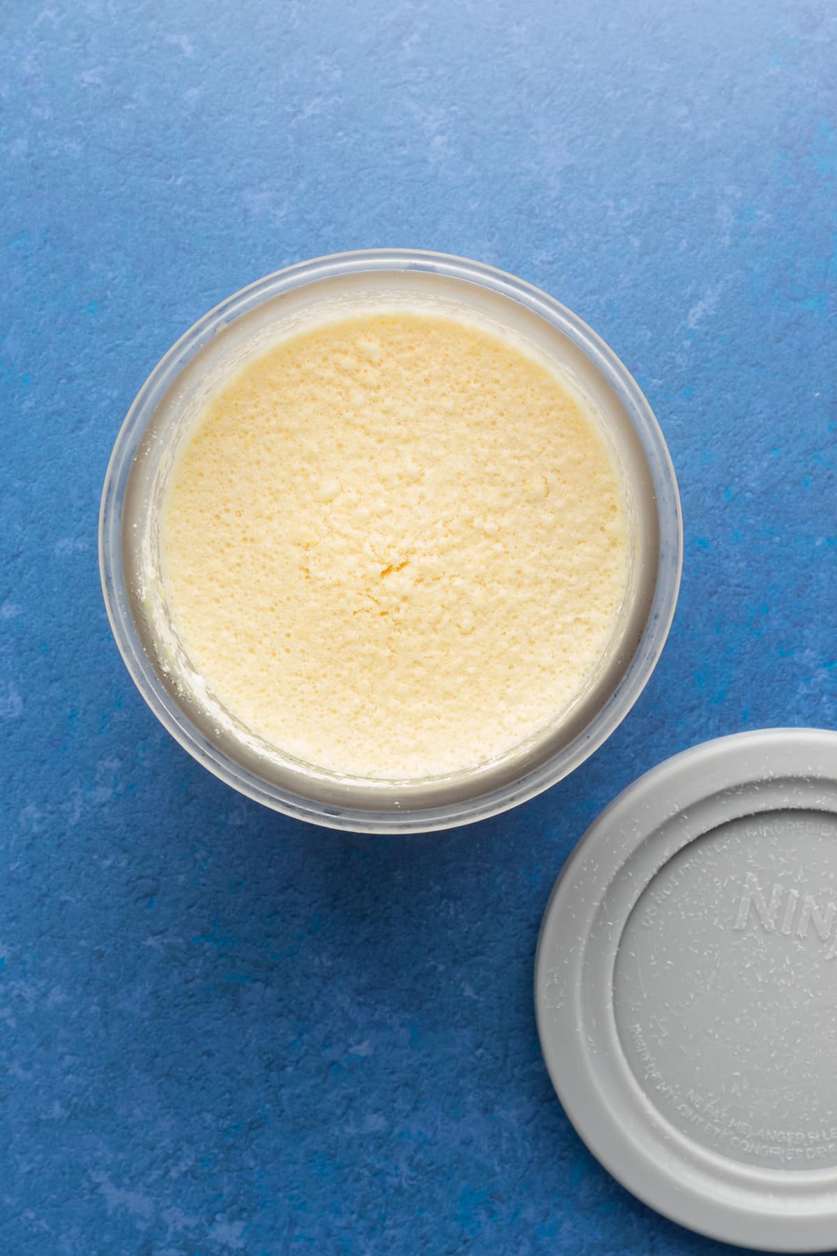 Ninja Creami protein ice cream frozen in a pint container.