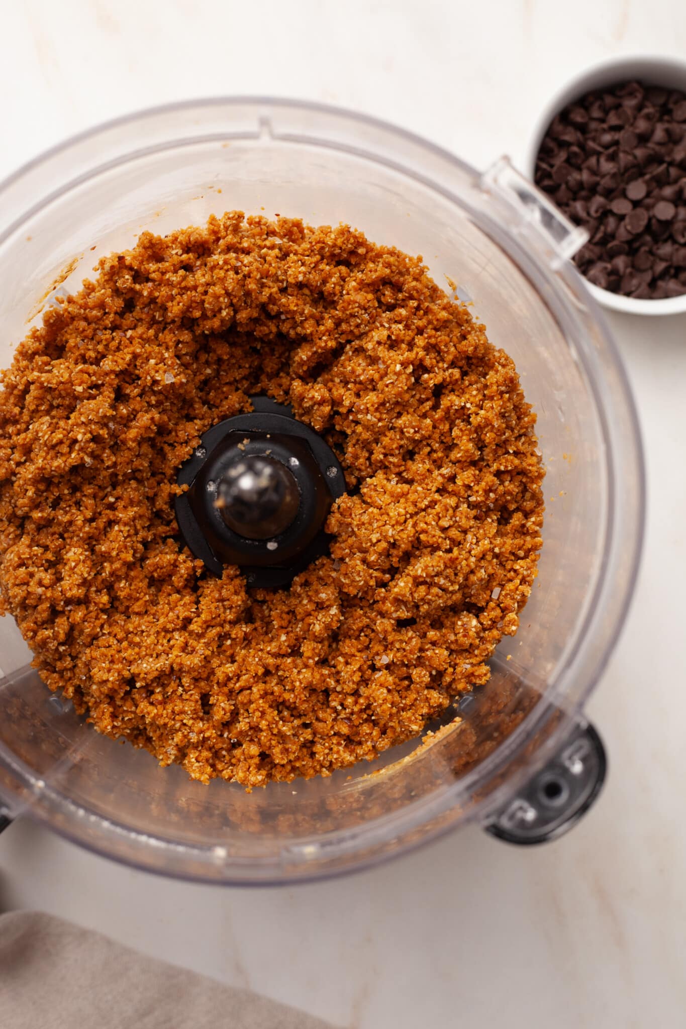 Pumpkin protein ball ingredients mixed in a food processor.