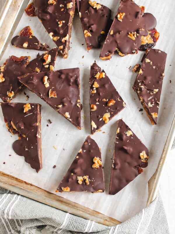 Chocolate date bark on a sheet pan with parchment paper.