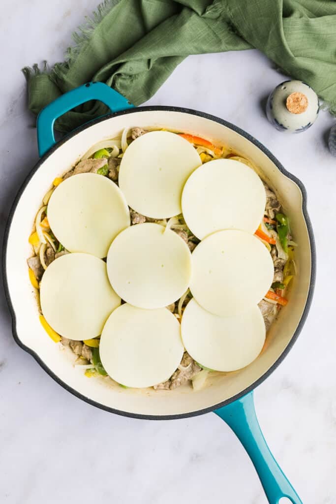 Philly cheesesteak casserole topped with provolone cheese.