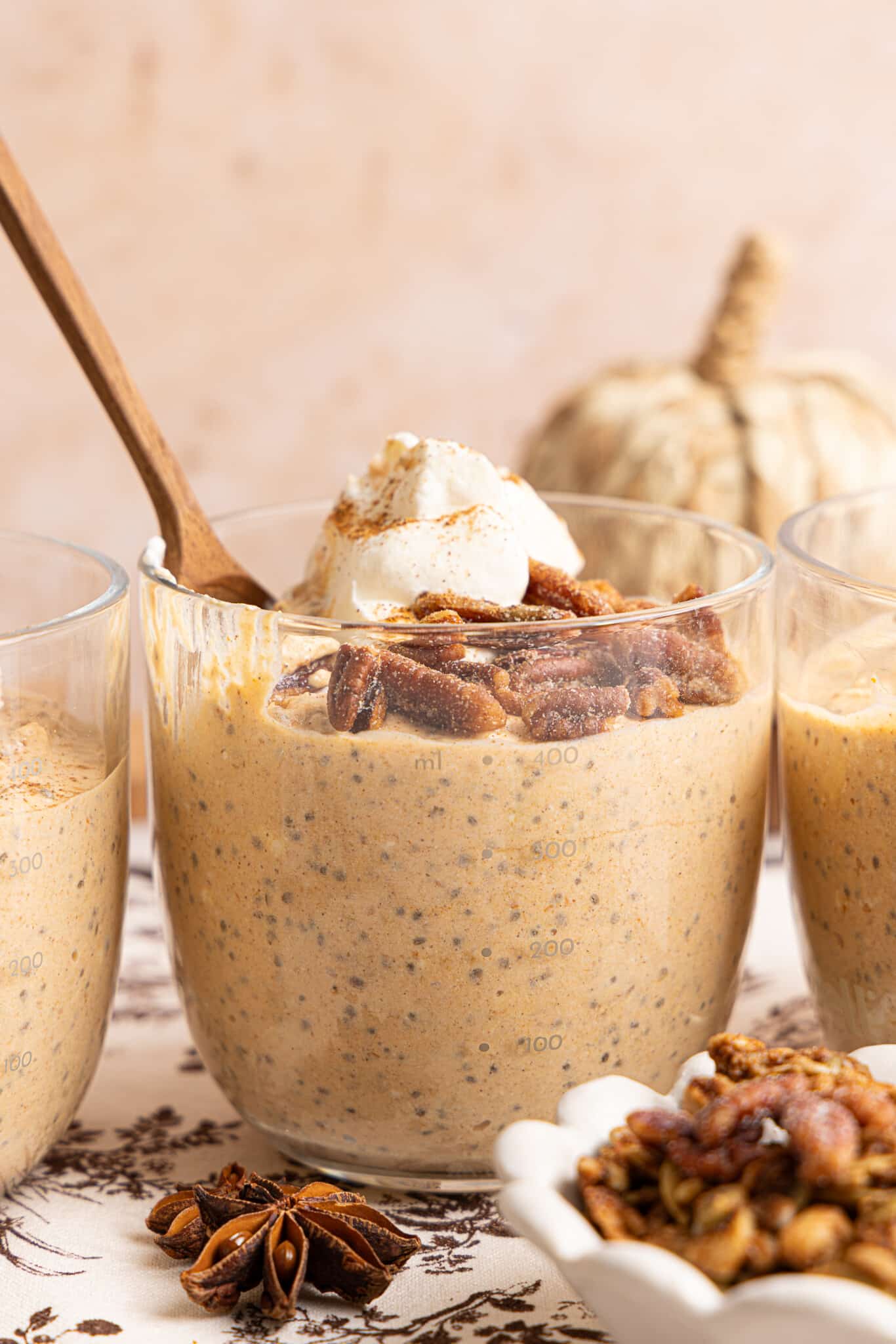 The pumpkin overnight oats in a jar topped with pecans and a dollop of yogurt.
