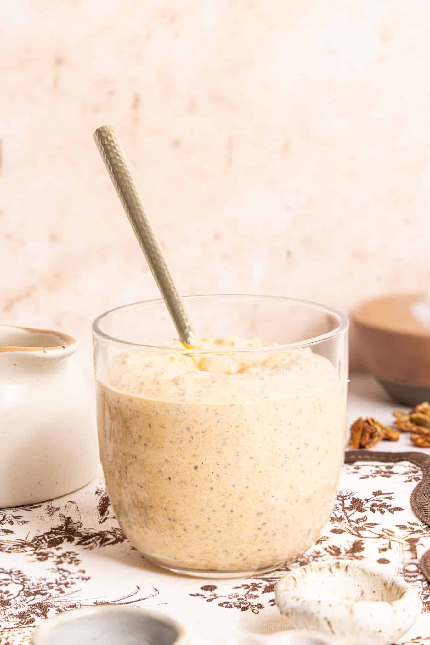 Everything for the overnight oats mixed together in a glass jar on a countertop.