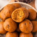 Pumpkin protein balls piled on a plate.
