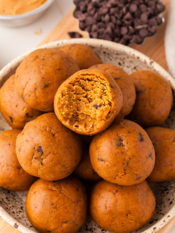 Pumpkin protein balls piled on a plate.