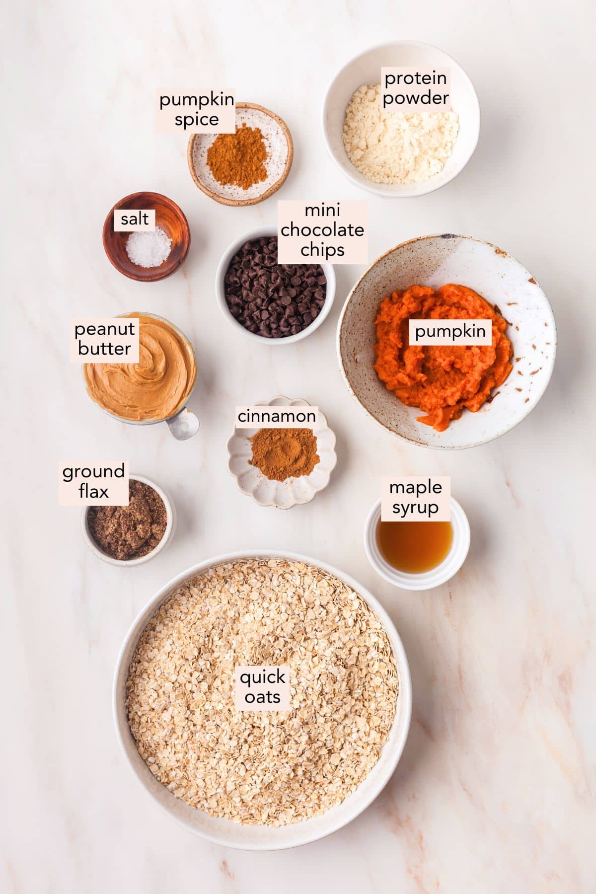 Ingredients for pumpkin protein balls on a countertop with labels.