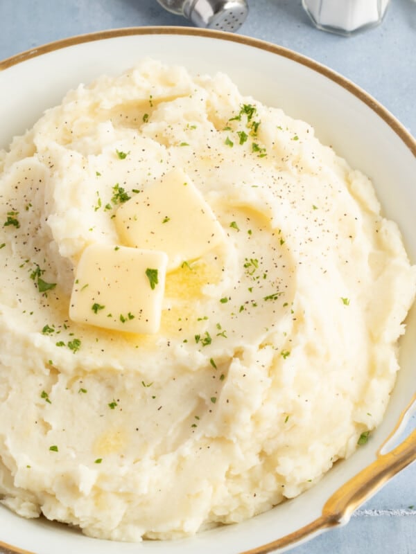 Cottage cheese mashed potatoes in a large bowl topped with butter.