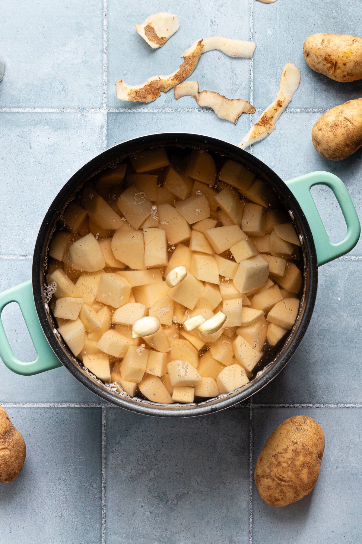 Cubed potatoes and garlic in a large pot of water.