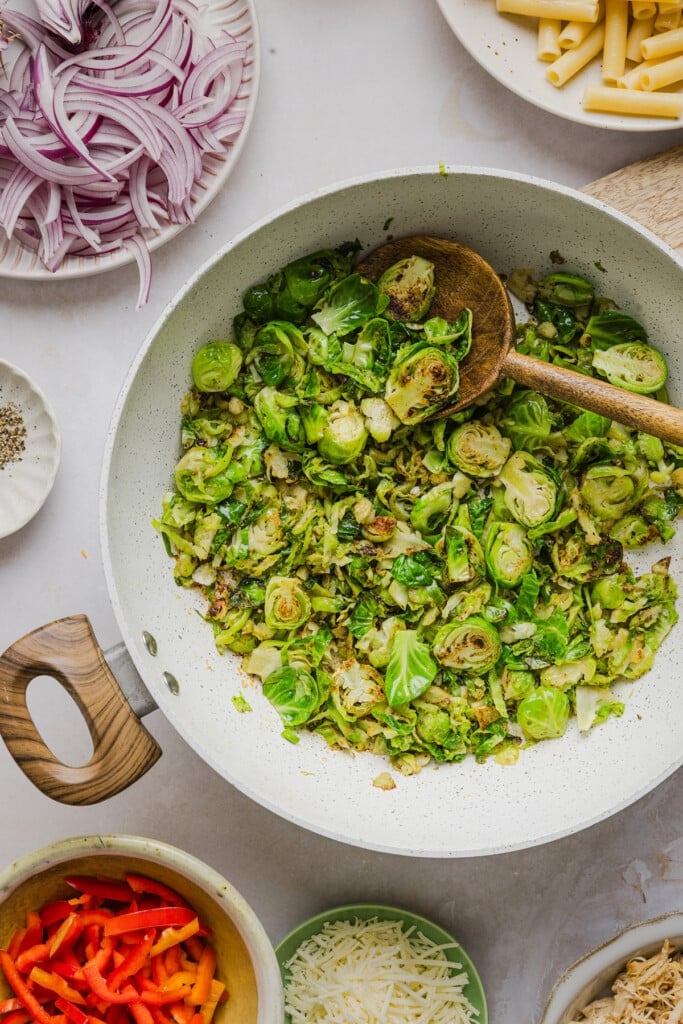 Sliced brussels sprouts being sautéed in a pan.