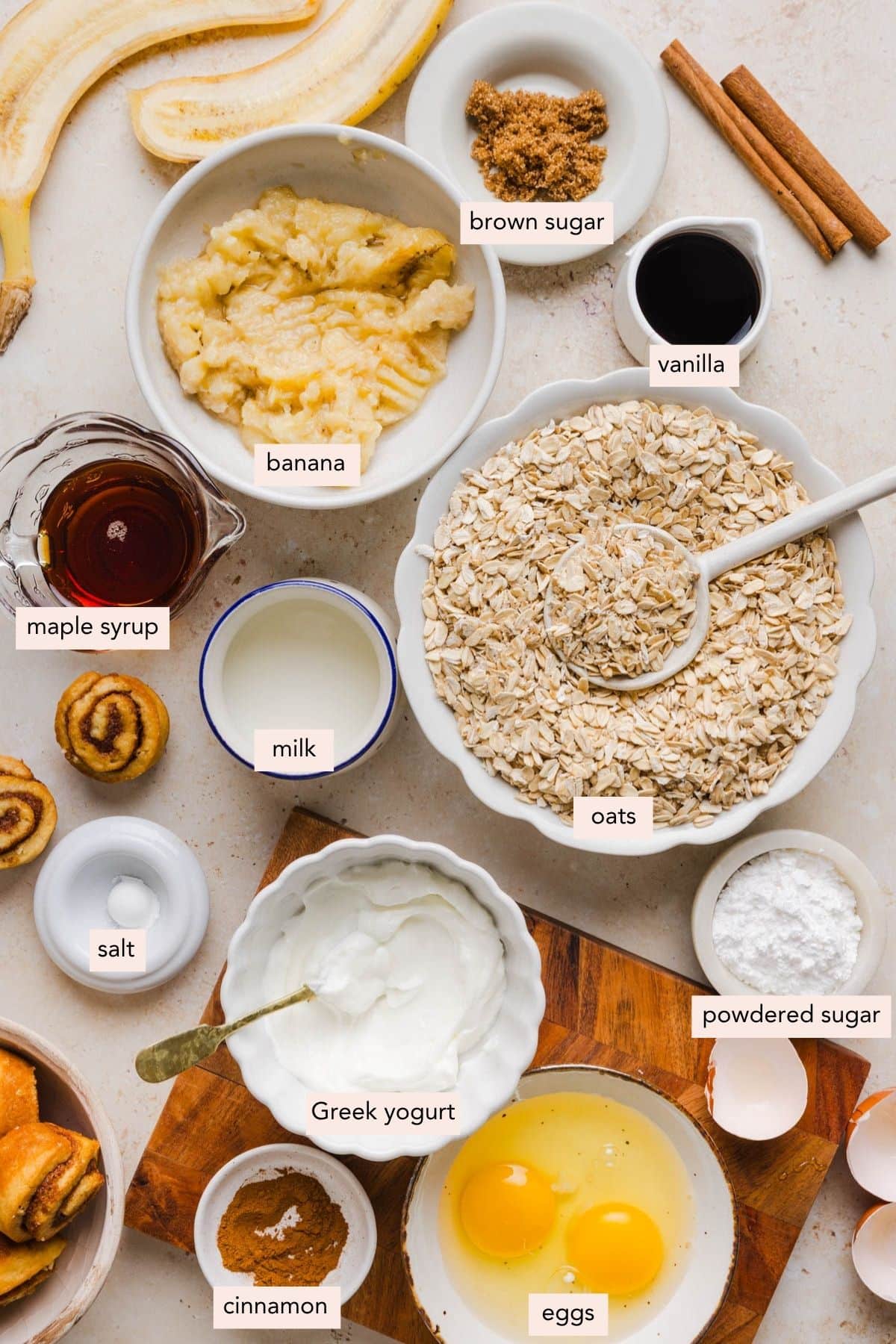 All of the ingredients for cinnamon roll baked oats in bowls on a countertop.