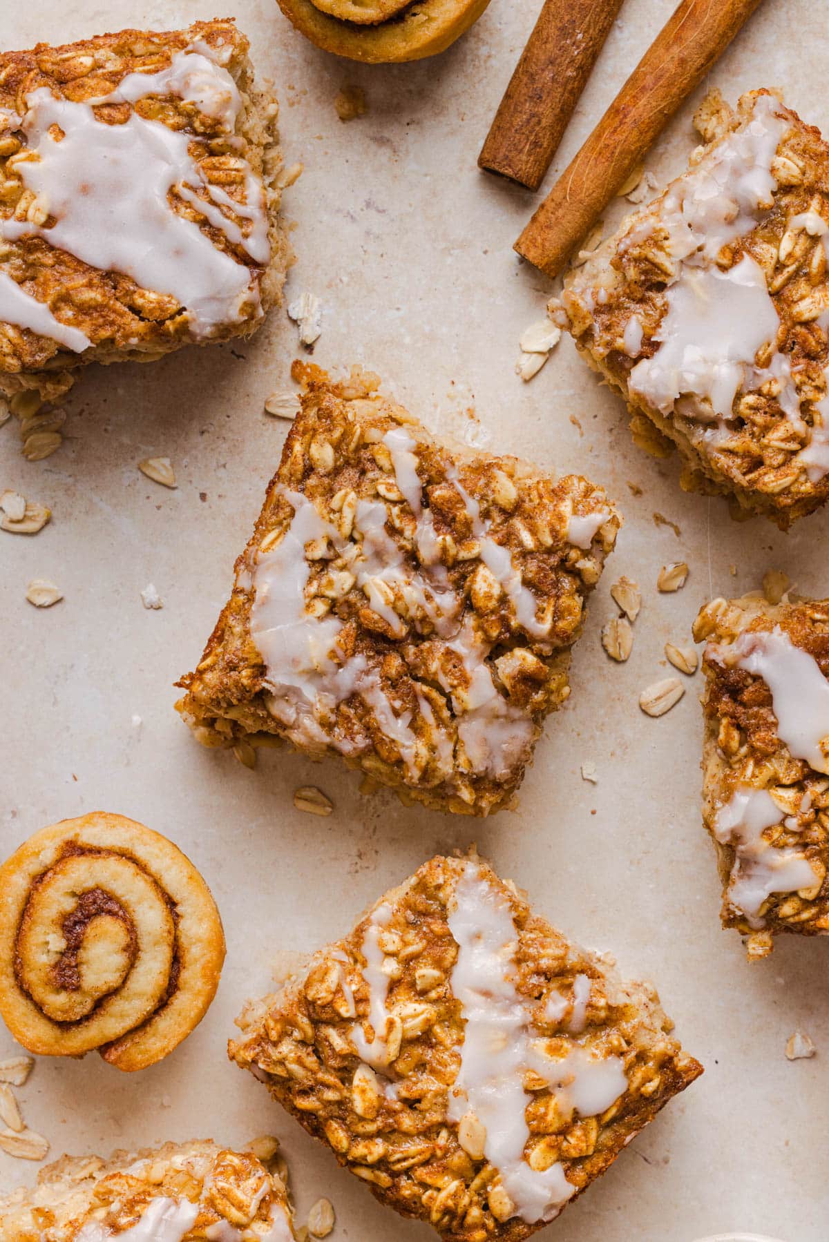 Slices of cinnamon roll baked oatmeal on a white background before serving.