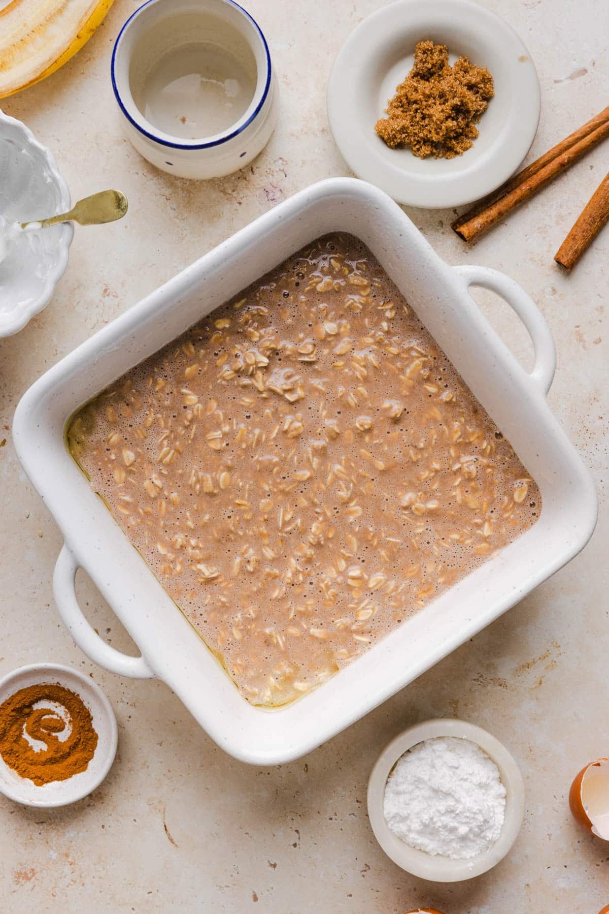 The oatmeal batter in a square baking dish before baking.