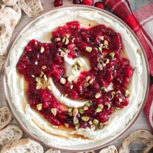 Whipped feta dip topped with homemade cranberry sauce and sprinkled with maple syrup and pistachios.