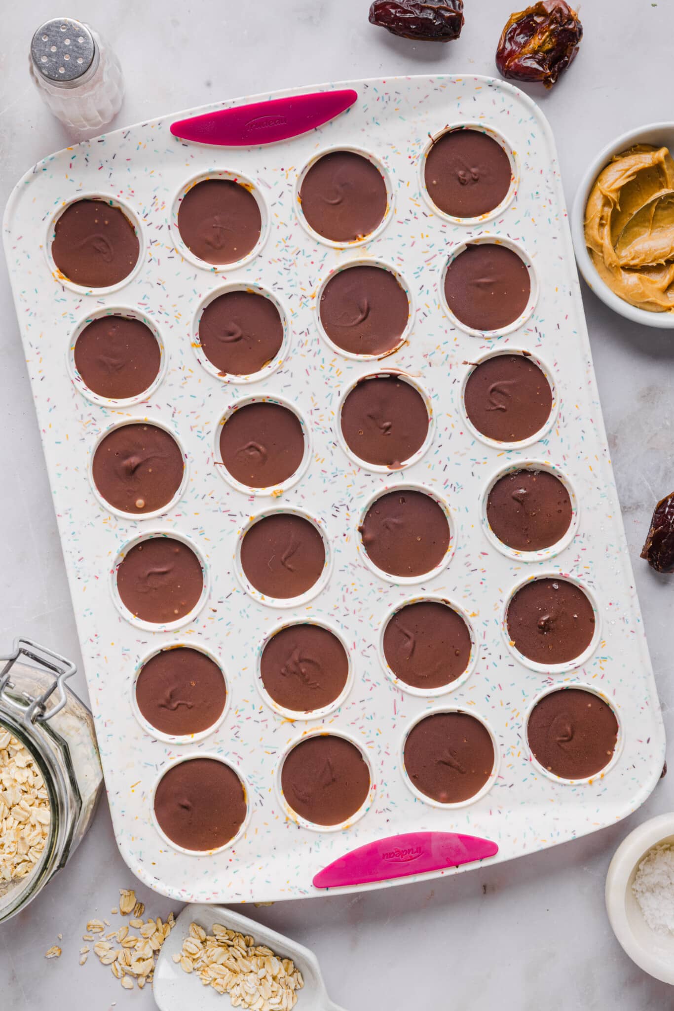 Healthy Twix bites set in a mini silicone muffin pan.