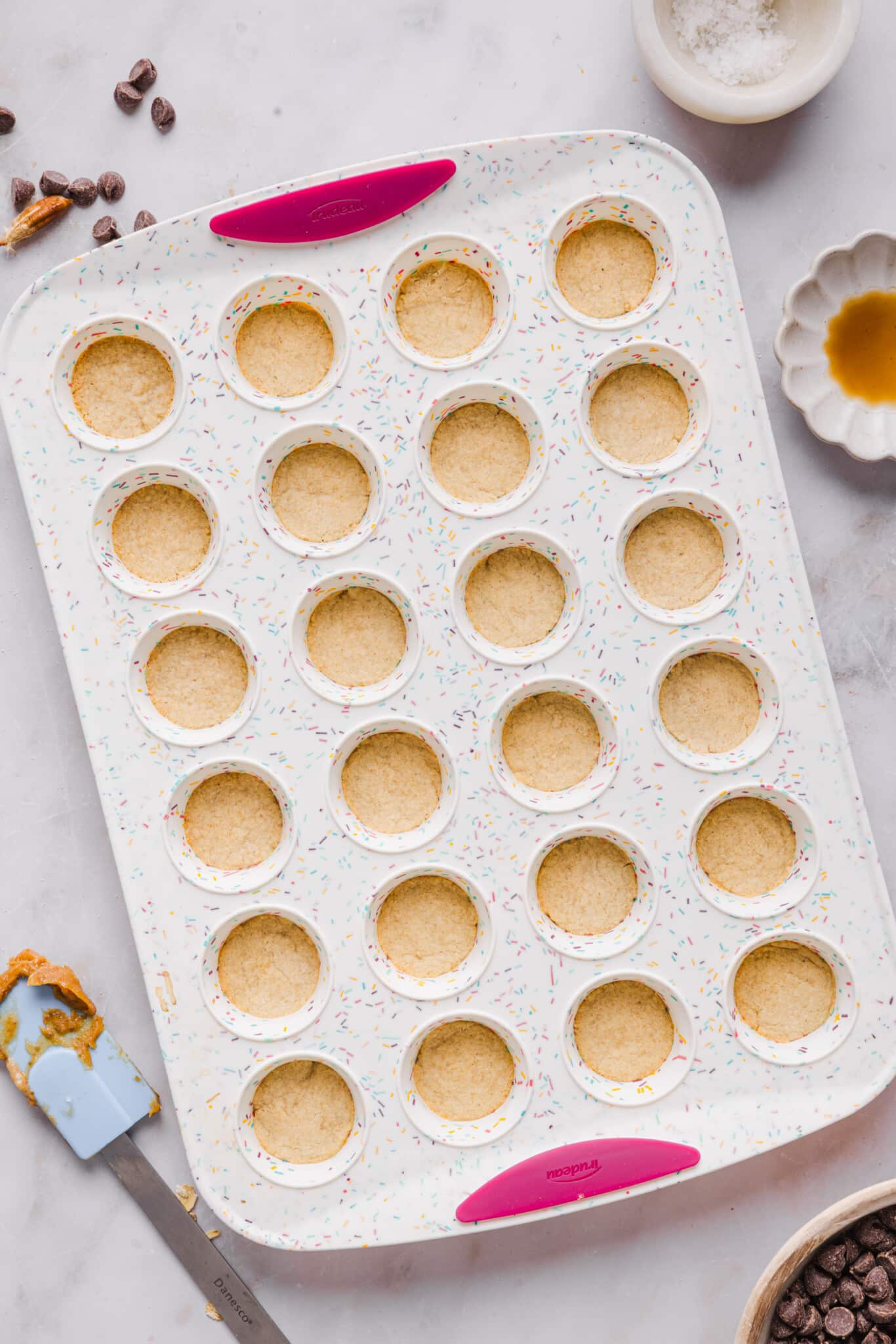 Healthy twix bites shortbread baked in a mini muffin pan.