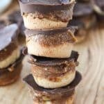 A close up shot of four stacked homemade healthy twix cups.