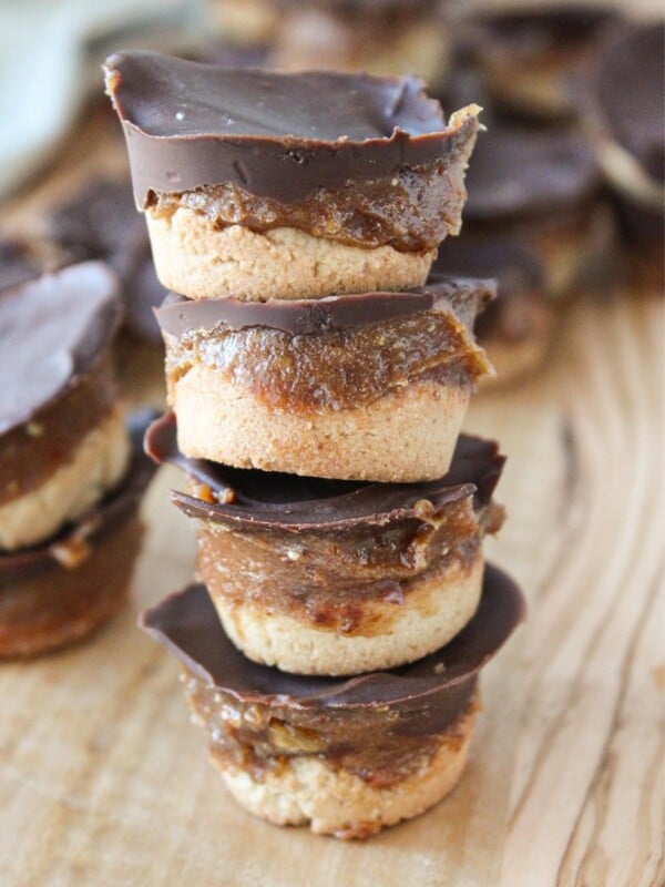 A close up shot of four stacked homemade healthy twix cups.