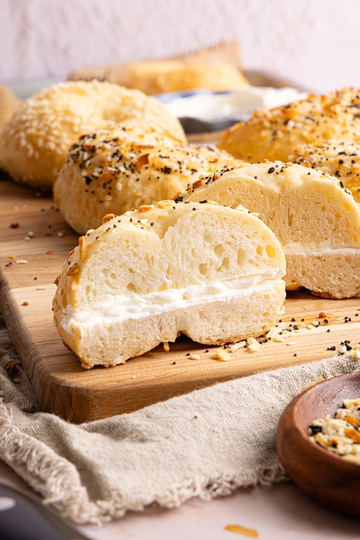 A cottage cheese bagel sliced in half with cream cheese.
