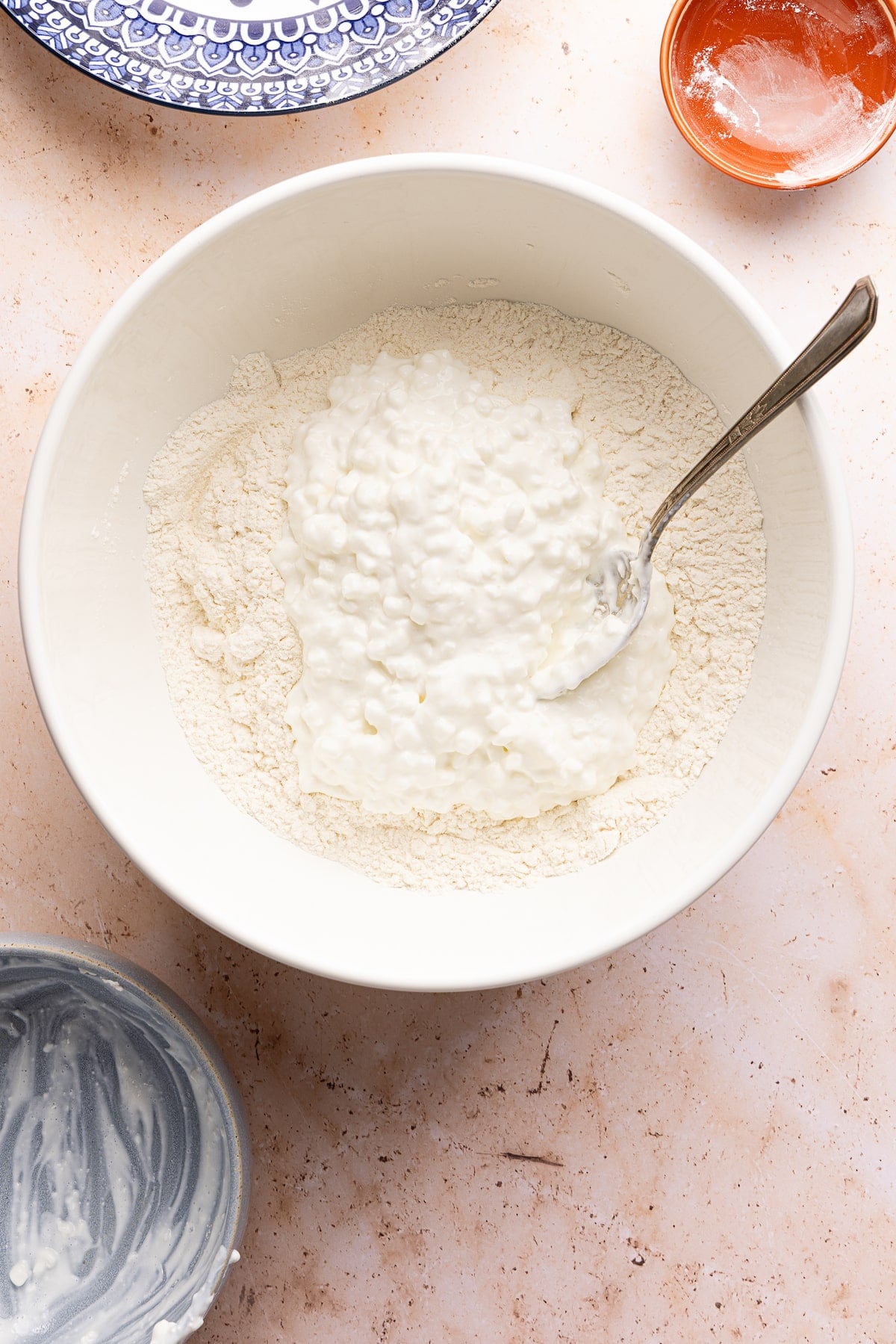 Cottage cheese, flour and baking powder in a mixing bowl.