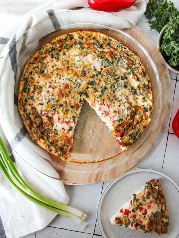 An egg white quiche with a slice cut out.
